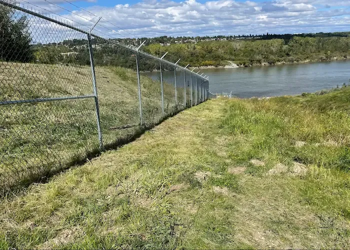 Mowed fence line along river bank
