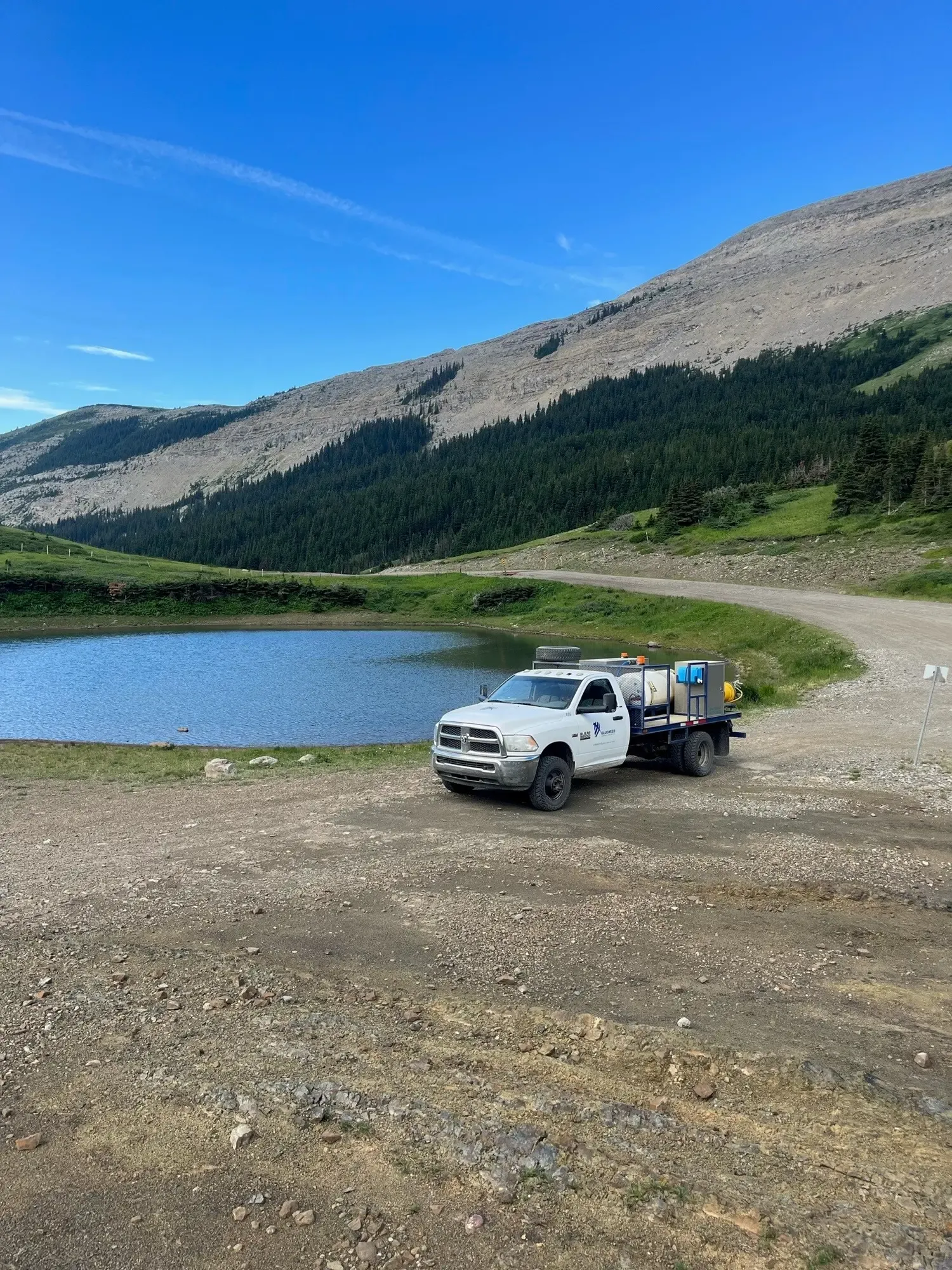 Spray truck near mountain lake