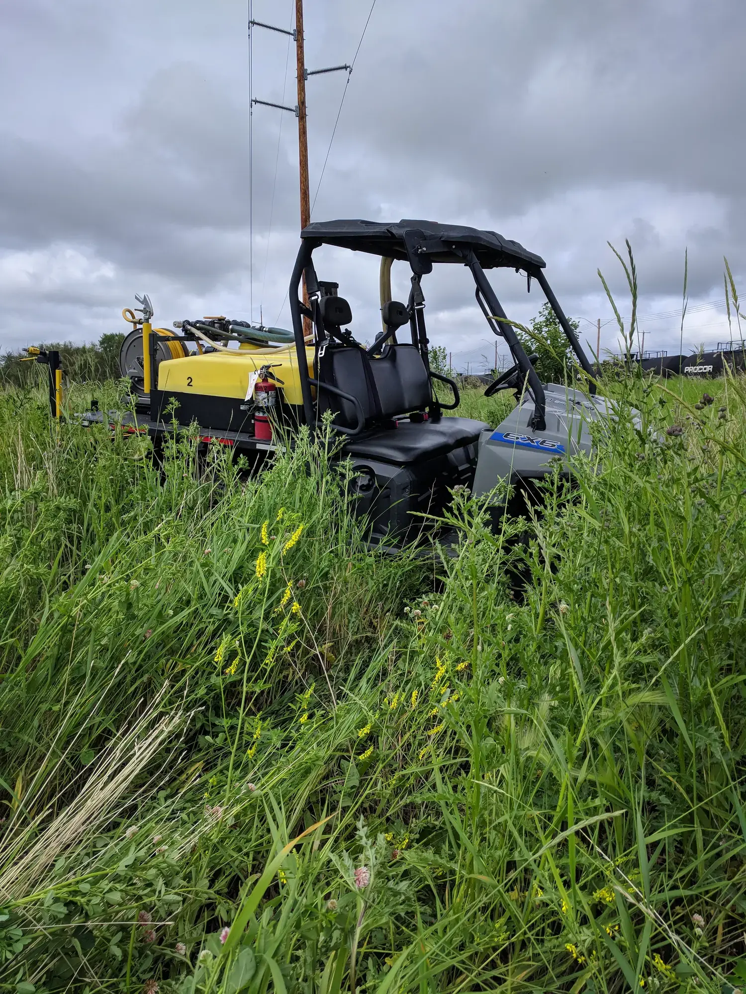 Worker performing brush control with backpack sprayer