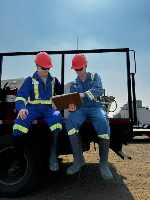 Blueweed workers reviewing safety documentation on job site